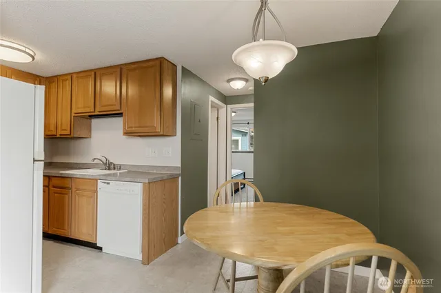 a kitchen with stainless steel appliances granite countertop a sink and cabinets