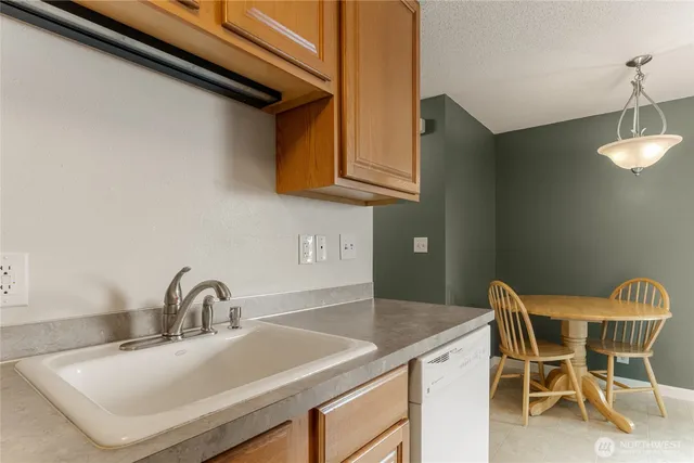 a kitchen with a sink cabinets and a wooden floor