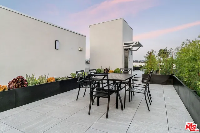 a view of outdoor dining space with a table and chairs