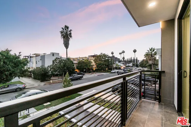 a view of a house with roof stairs and potted plants