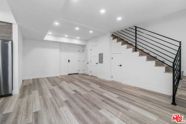 a kitchen with stainless steel appliances granite countertop a stove a refrigerator and a sink