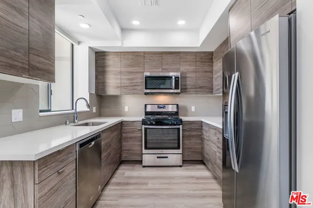 a bathroom with a toilet sink vanity and mirror