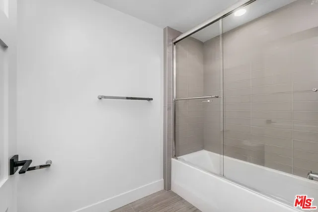 an empty room with wooden floor and window