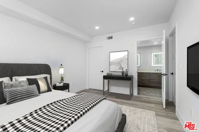 a bedroom with a bed and a view of bedroom