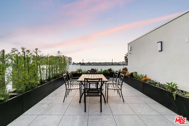 a terrace with outdoor seating and city view