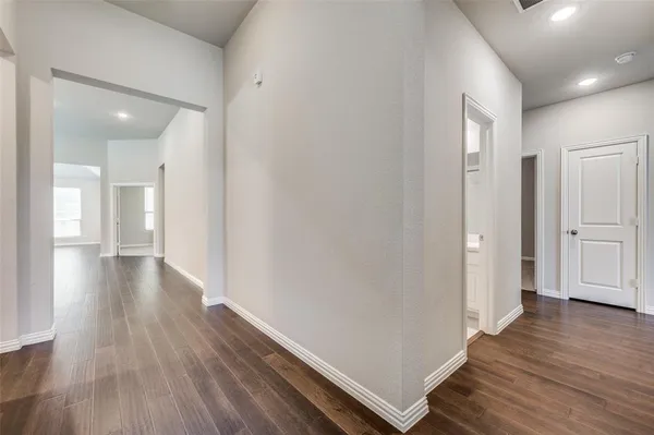a view of a hallway with wooden floor