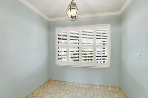 a view of a hallway with closet and window