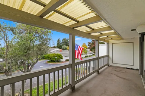 a view of a hallway with wooden floor and stairs