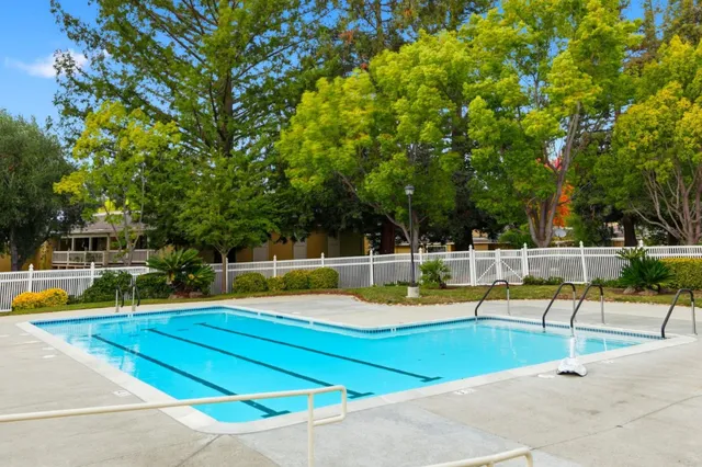 swimming pool view with a seating space