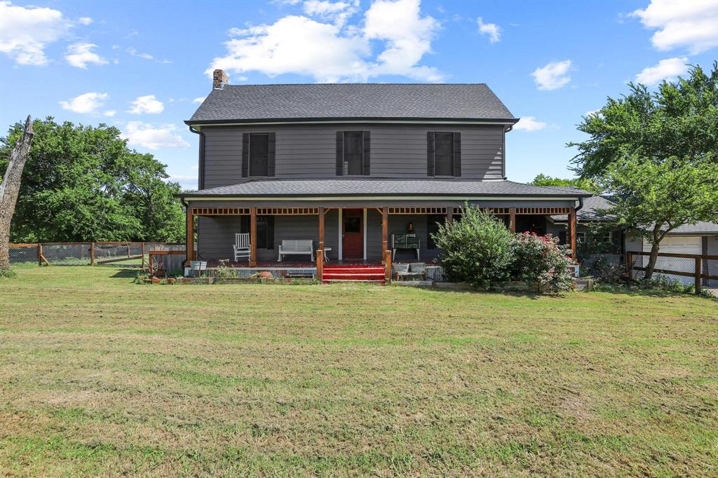 4453 Farm To Market 902 Howe, TX 75459 - Photo 2 of 40 Two-story residence with a covered front porch, dark gray siding, and black window shutters