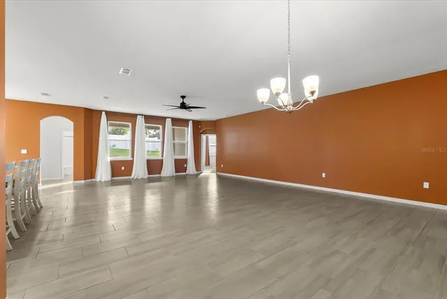 a kitchen with kitchen island cabinets and chairs in it