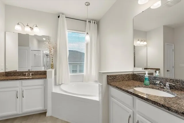 a bathroom with a granite countertop sink a toilet and shower