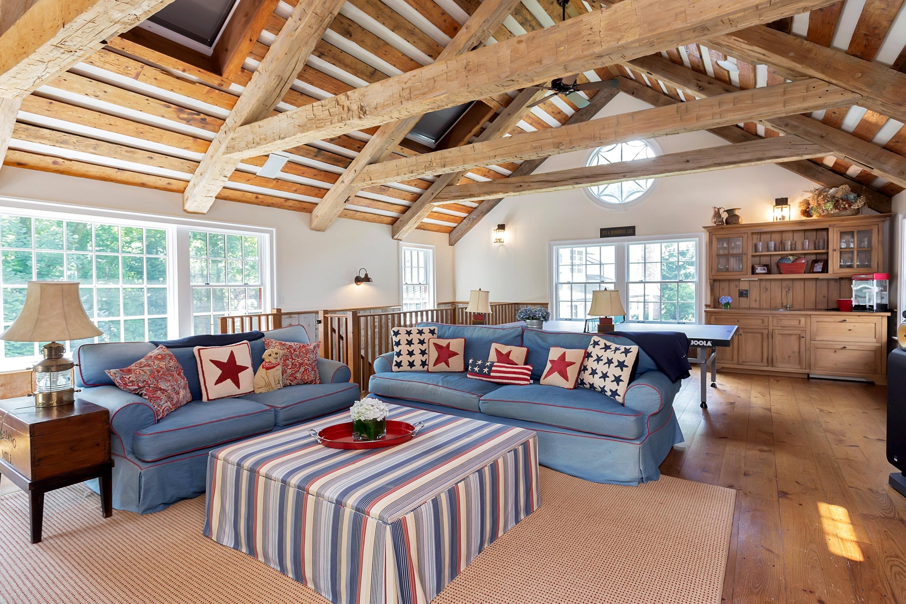350 Hollow Tree Ridge Road Darien, CT 06820 - Photo 29 of 40 a living room with lots of furniture and a book shelf