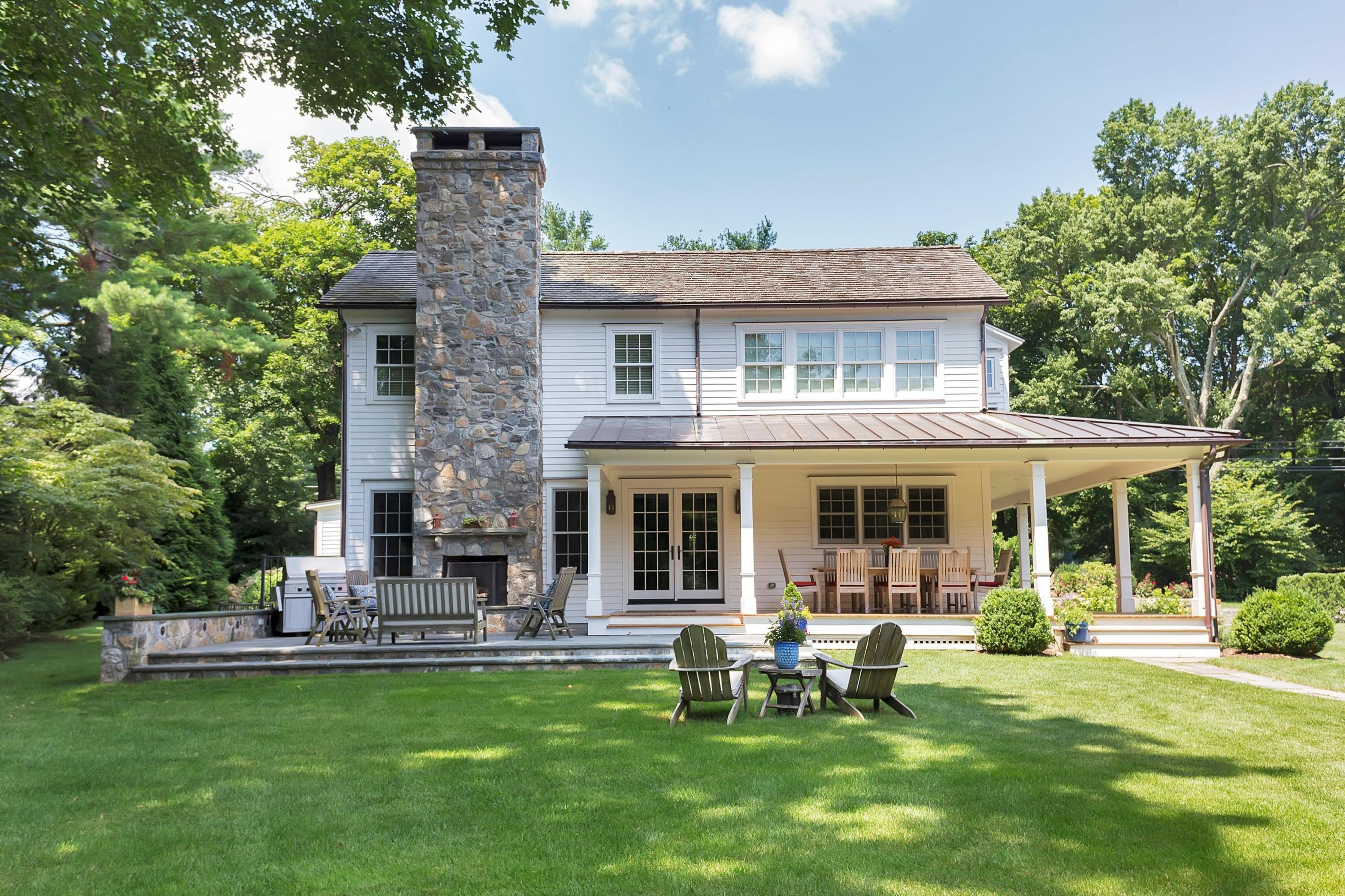 350 Hollow Tree Ridge Road Darien, CT 06820 - Photo 4 of 40 a front view of a house with a garden and patio