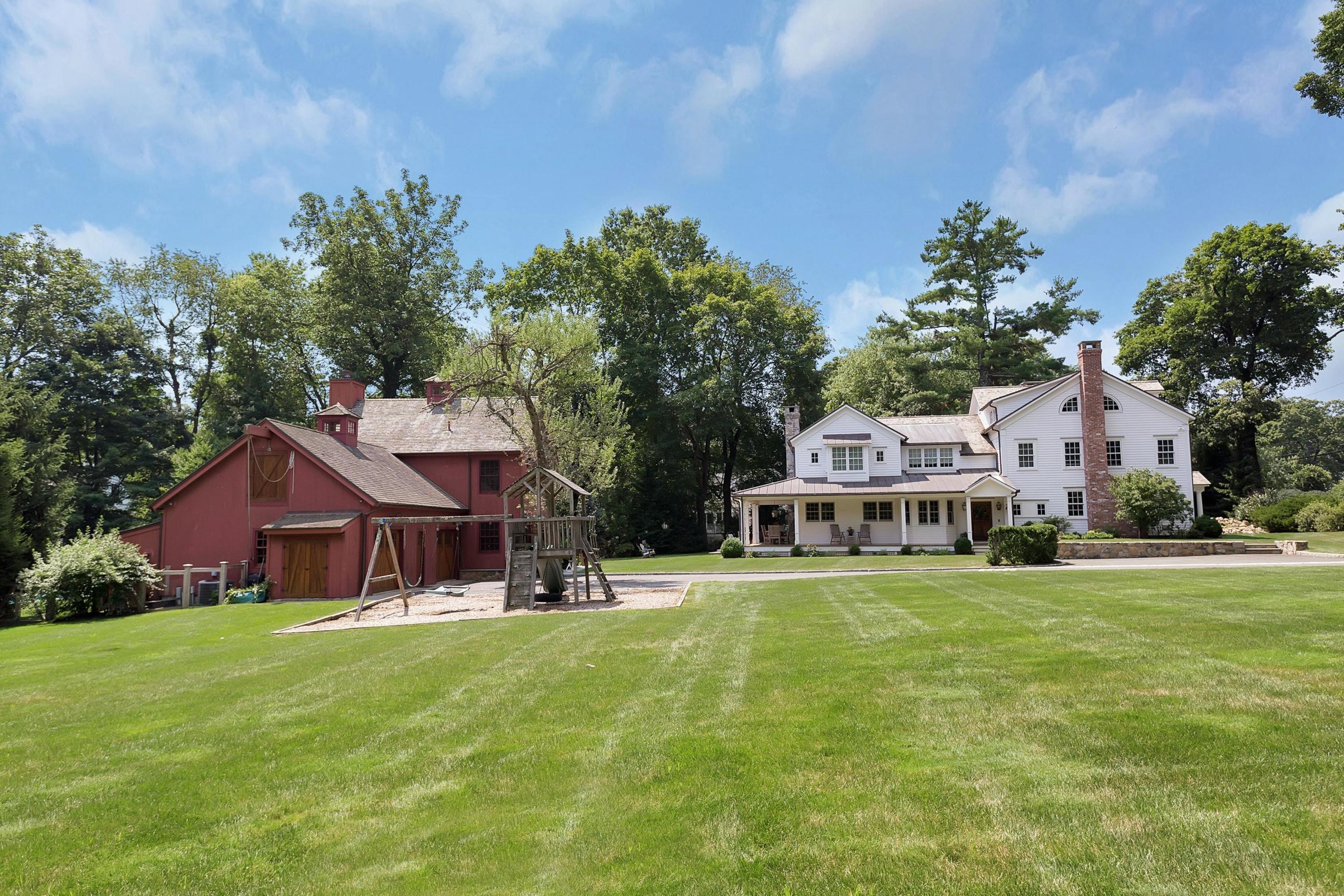 350 Hollow Tree Ridge Road Darien, CT 06820 - Photo 34 of 40 a front view of a house with a garden and trees