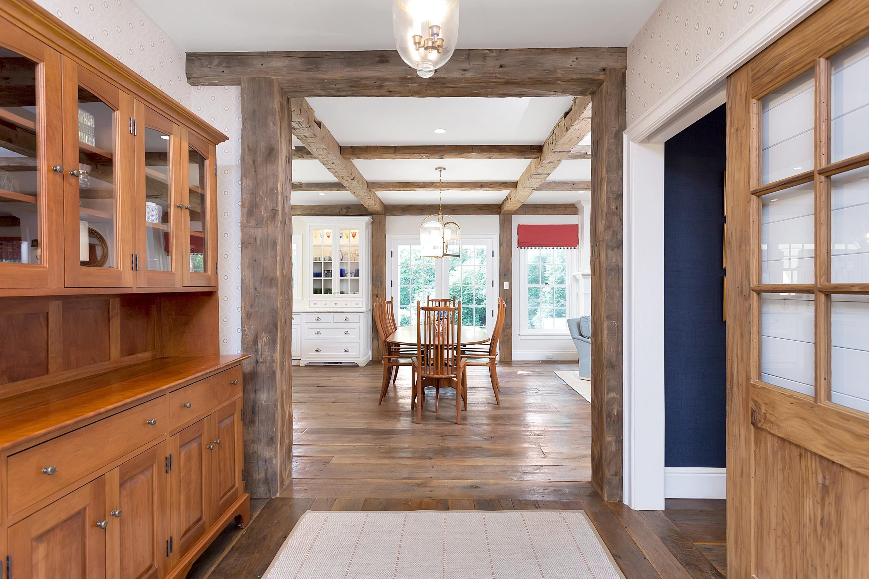 350 Hollow Tree Ridge Road Darien, CT 06820 - Photo 9 of 40 a hallway with wooden floor and chandelier