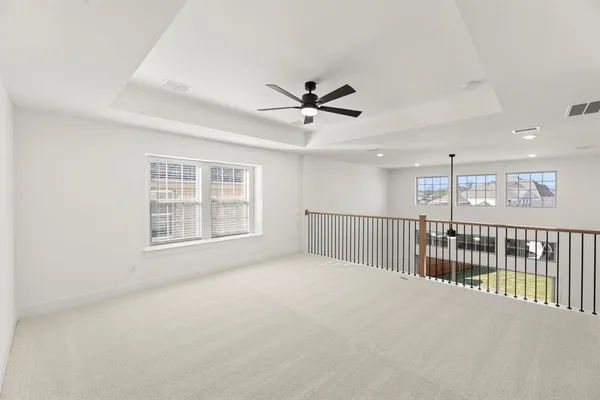 a view of a livingroom with a ceiling fan and window