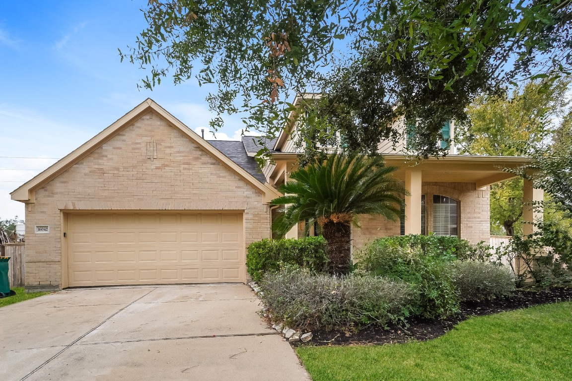 16042 Belleshire Lane Houston, TX 77084 - Photo 1 of 18 a front view of house with yard and trees