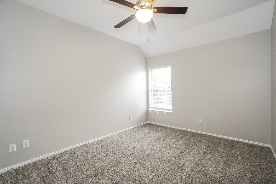 16042 Belleshire Lane Houston, TX 77084 - Photo 13 of 18 an empty room with a window and a fan