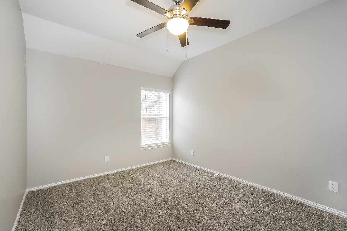 16042 Belleshire Lane Houston, TX 77084 - Photo 14 of 18 an empty room with windows and fan