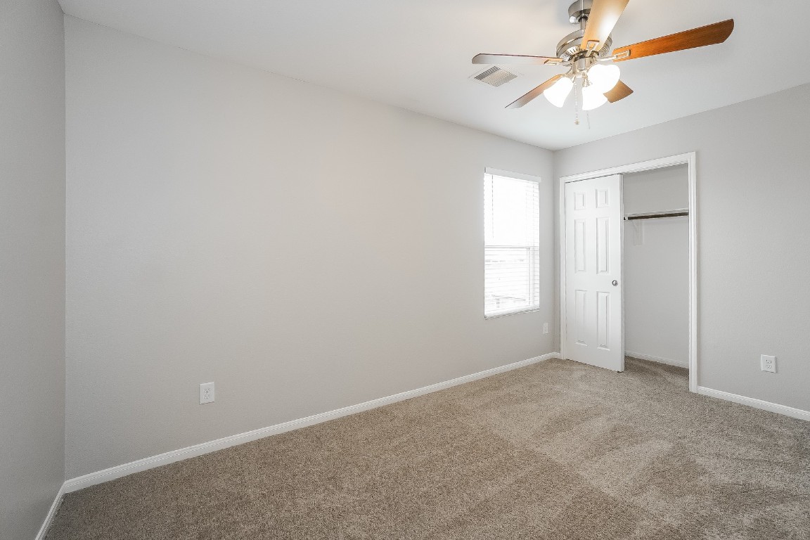 16042 Belleshire Lane Houston, TX 77084 - Photo 15 of 18 an empty room with windows and fan