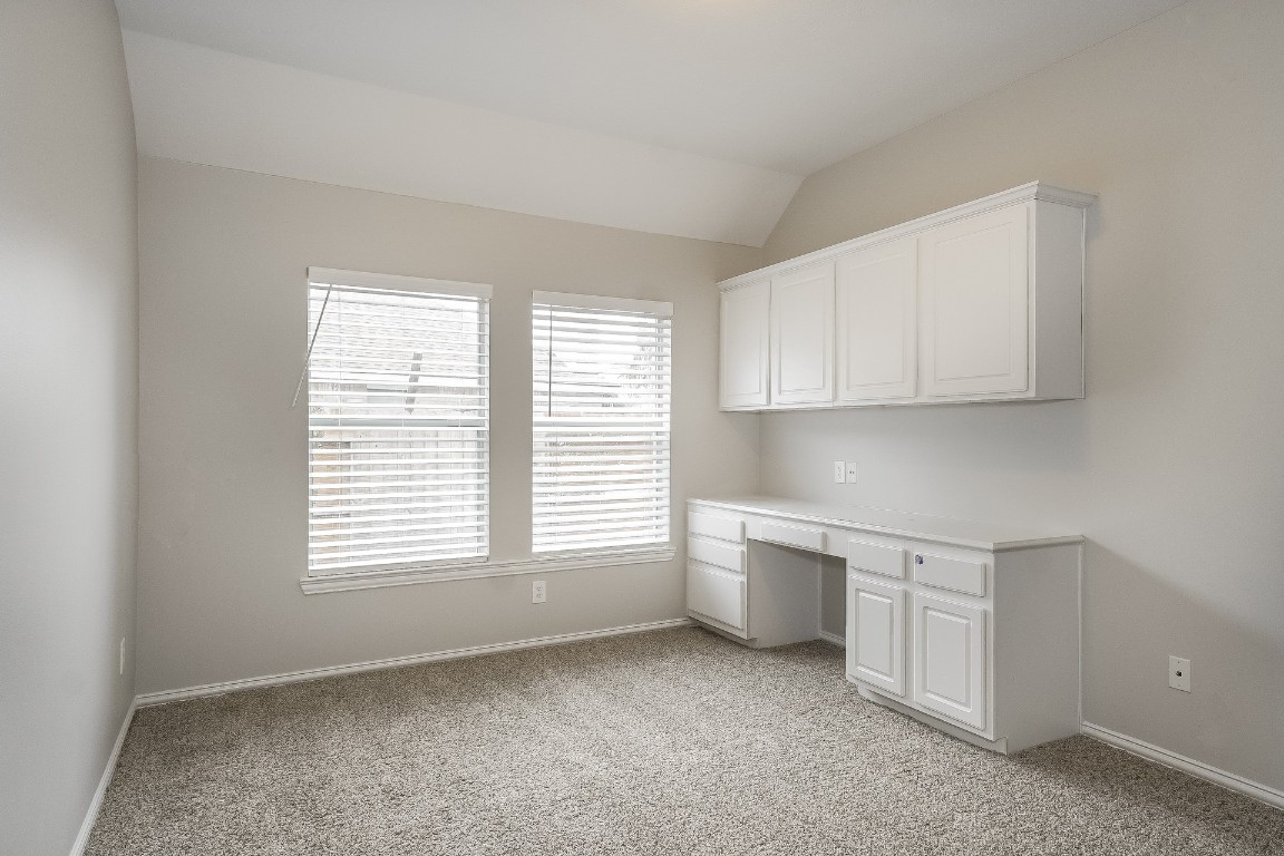 16042 Belleshire Lane Houston, TX 77084 - Photo 16 of 18 a room with a white cabinets and a window