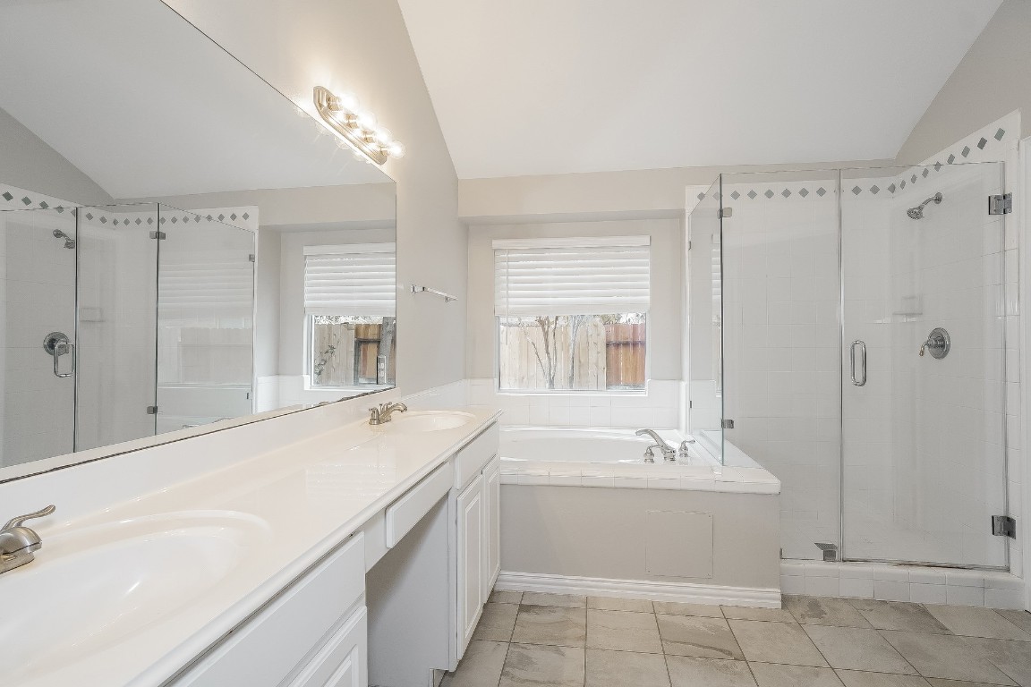 16042 Belleshire Lane Houston, TX 77084 - Photo 17 of 18 a bathroom with a sink a mirror and a bathtub