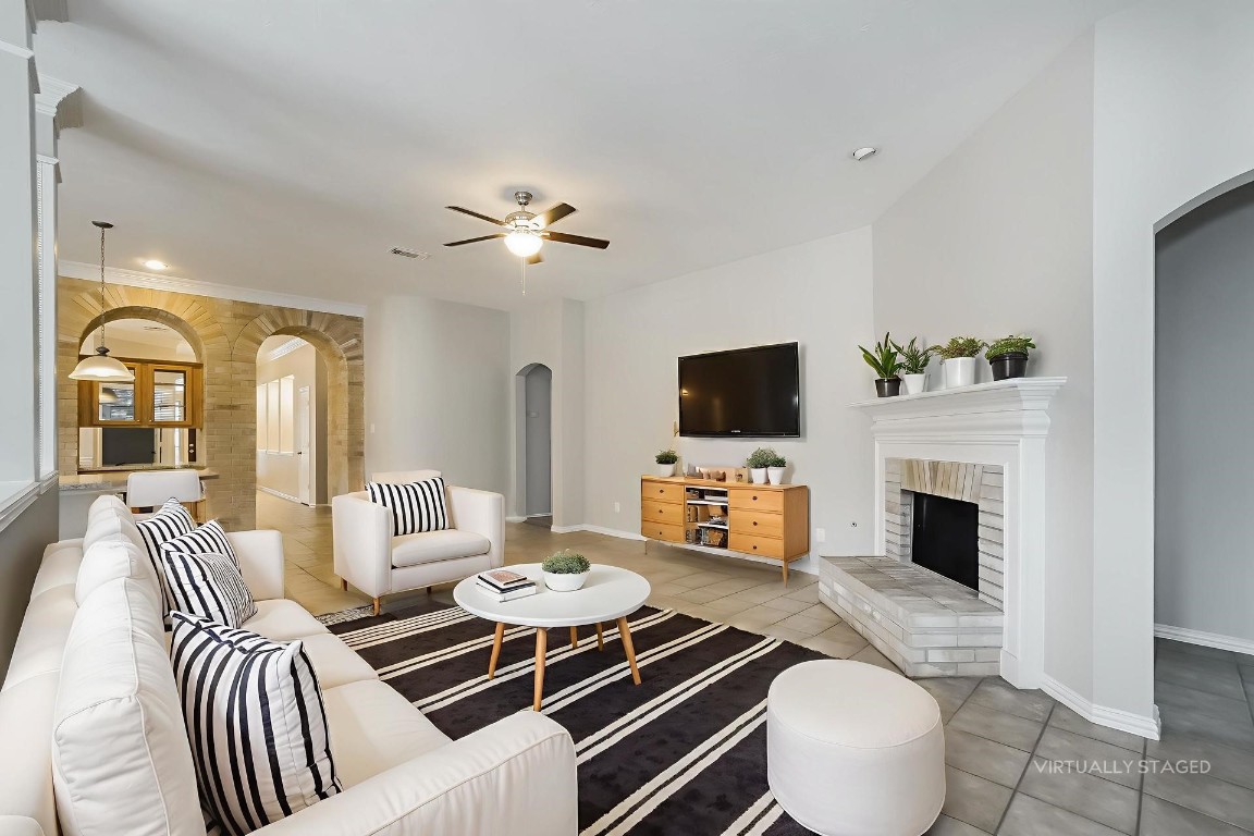 16042 Belleshire Lane Houston, TX 77084 - Photo 3 of 18 a living room with furniture fireplace and a flat screen tv