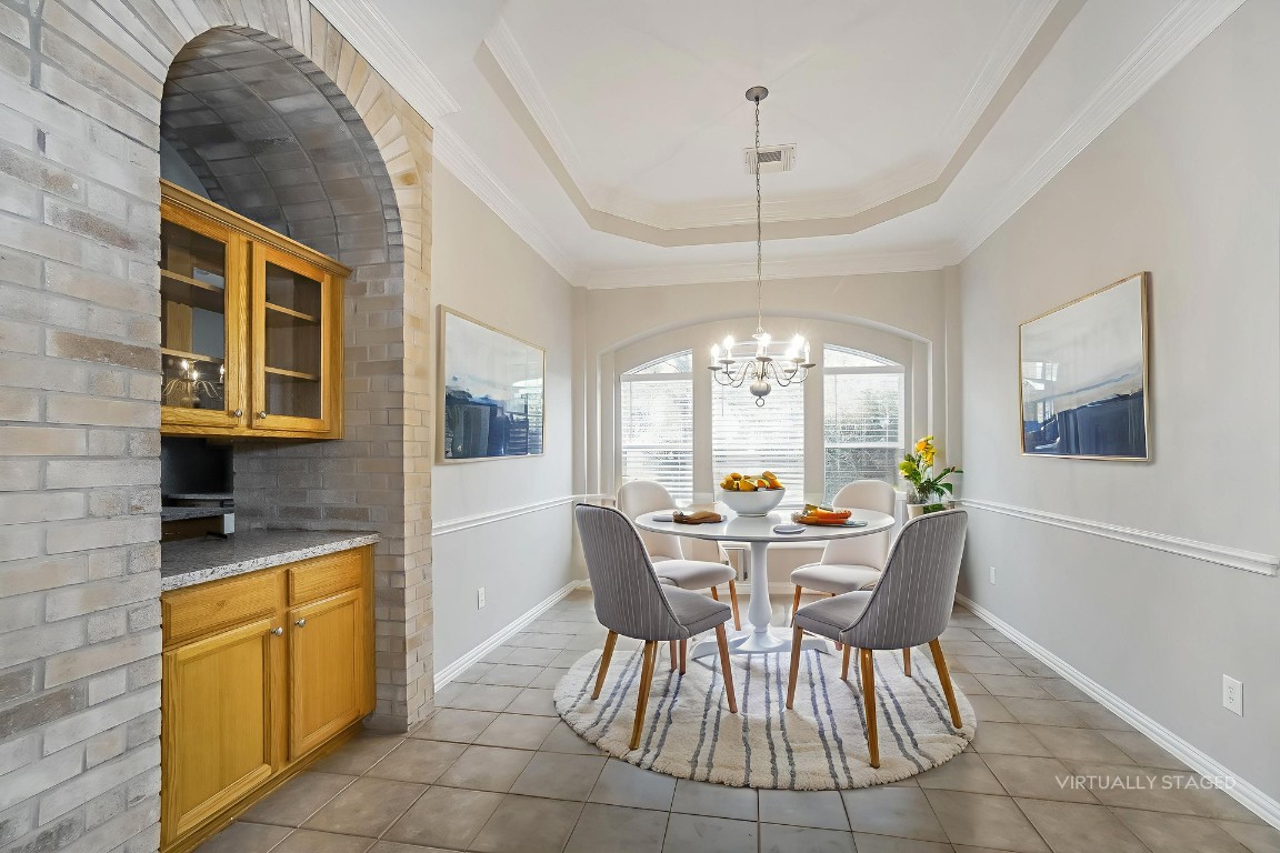 16042 Belleshire Lane Houston, TX 77084 - Photo 5 of 18 a view of a dining room with furniture wooden floor and chandelier