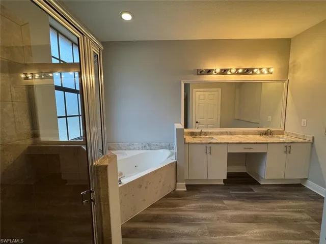 a kitchen with stainless steel appliances kitchen island wooden cabinets and granite counter tops