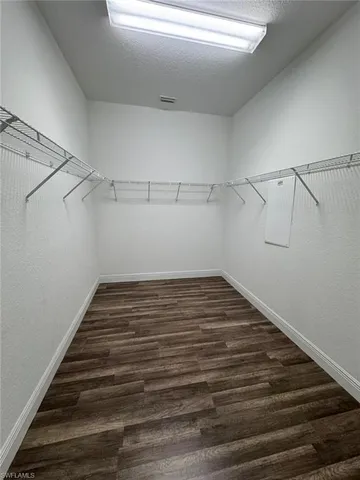 a bathroom with a granite countertop tub sink and mirror