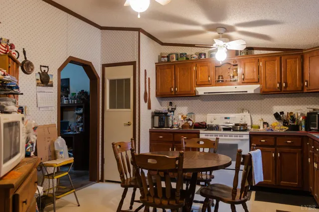 a view of a kitchen with fridge and workspace