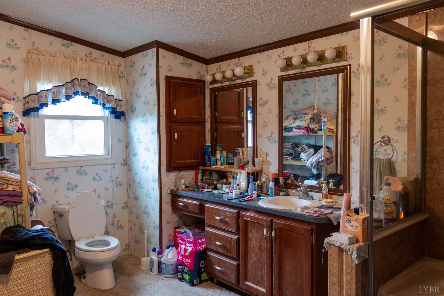 3160 Owens Mill Road Gretna, VA 24557 - Photo 21 of 59 a bathroom with a double vanity sink toilet and shower