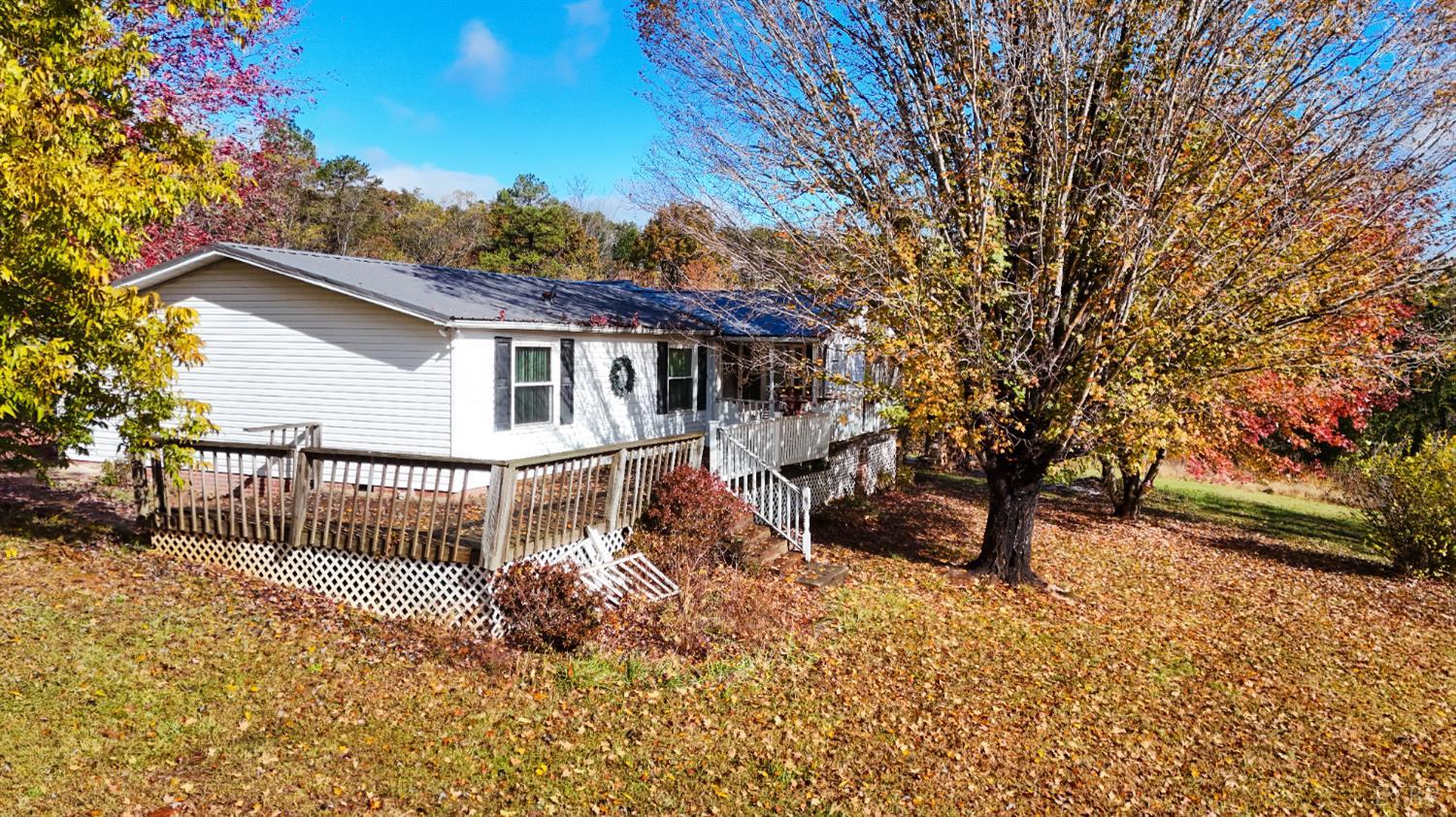 3160 Owens Mill Road Gretna, VA 24557 - Photo 48 of 59 a view of a house with a wooden deck and a tree