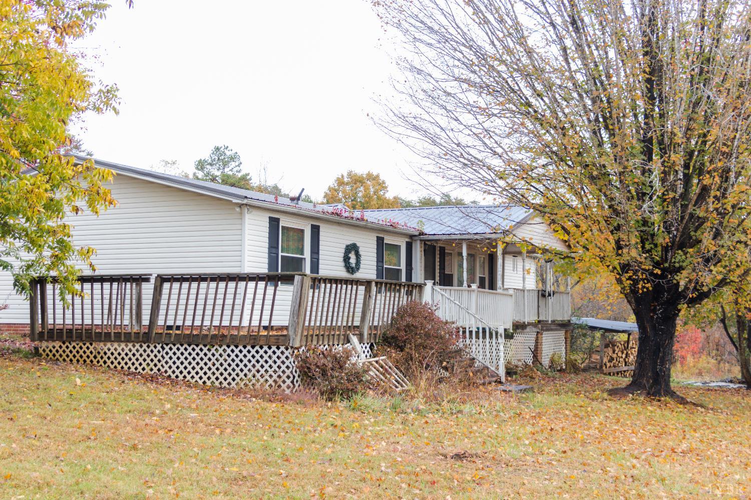 3160 Owens Mill Road Gretna, VA 24557 - Photo 5 of 59 a front view of a house with a large tree and a big yard