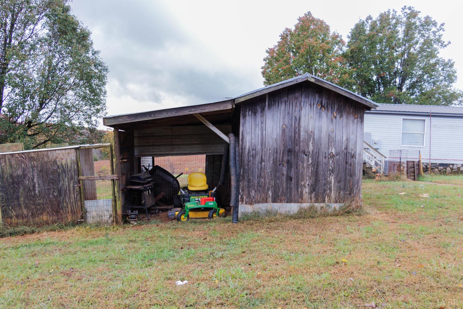 3160 Owens Mill Road Gretna, VA 24557 - Photo 57 of 59 a backyard of a house with childrens swings and slides