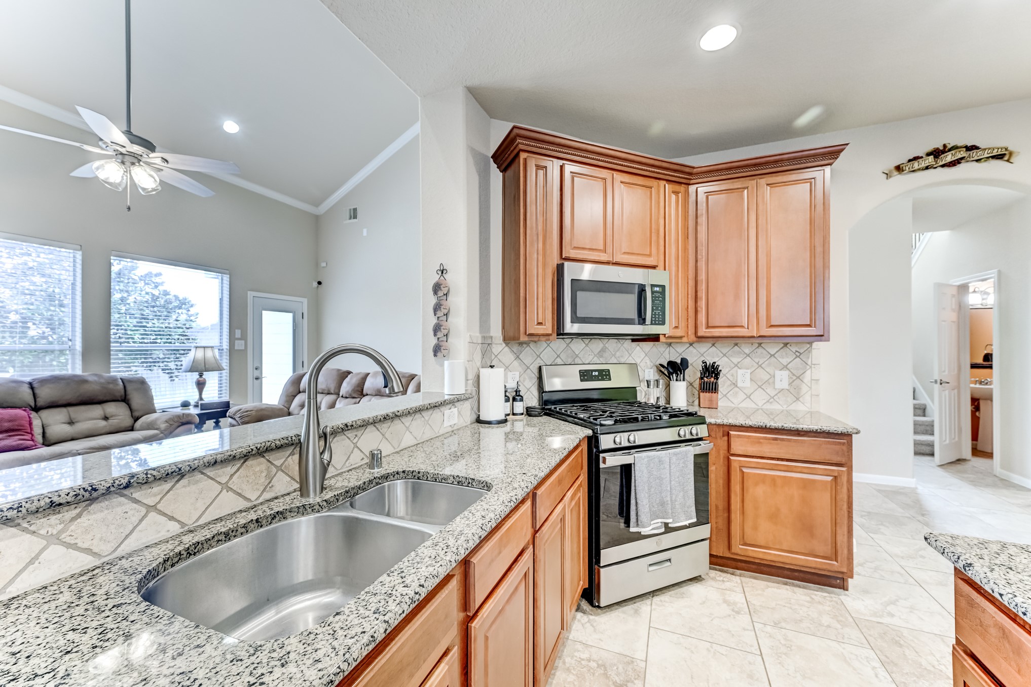 19502 Valkyrie Drive Spring, TX 77379 - Photo 16 of 49 a kitchen with granite countertop a sink stainless steel appliances and cabinets