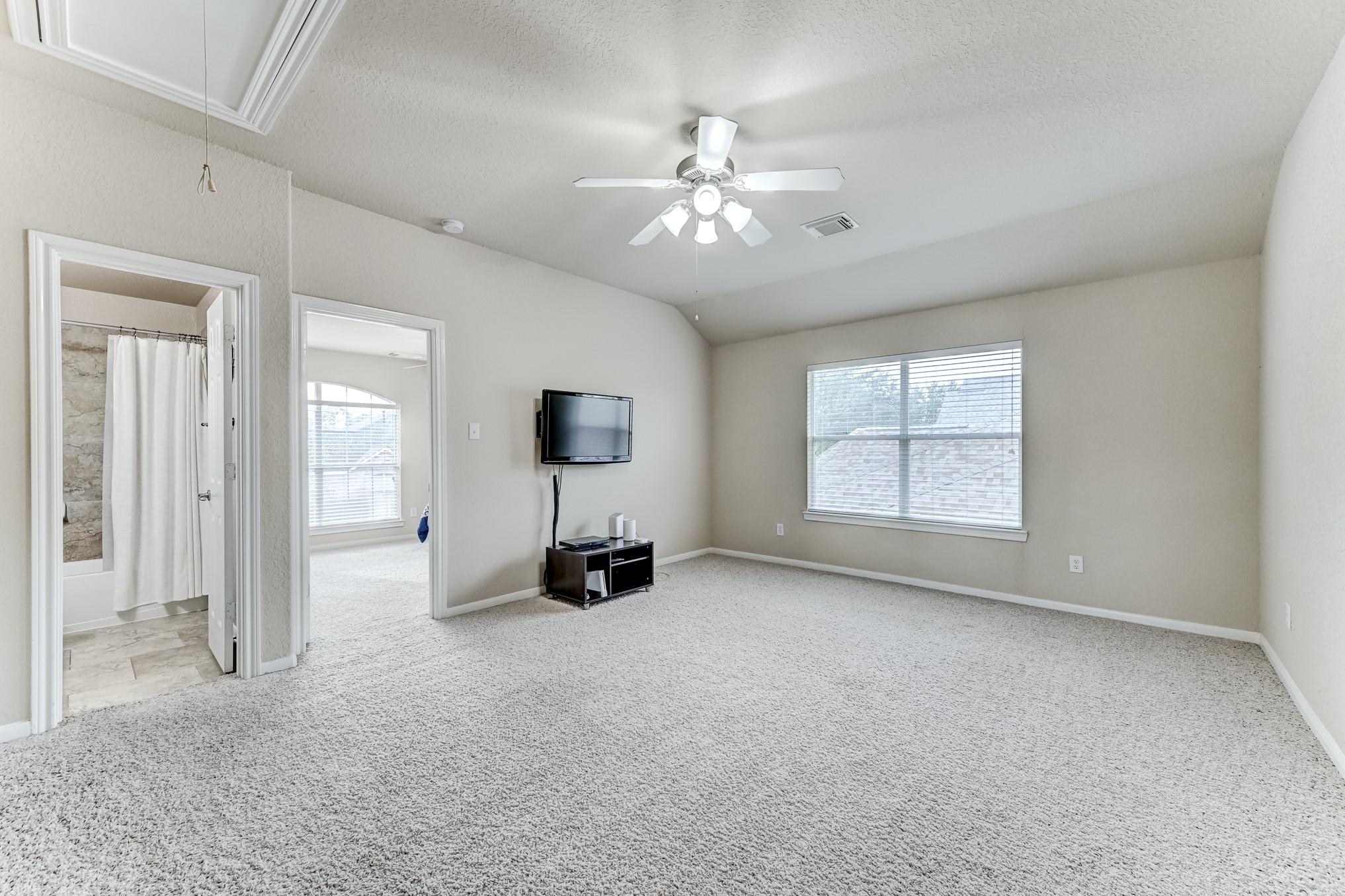 19502 Valkyrie Drive Spring, TX 77379 - Photo 34 of 49 an empty room with windows and fan