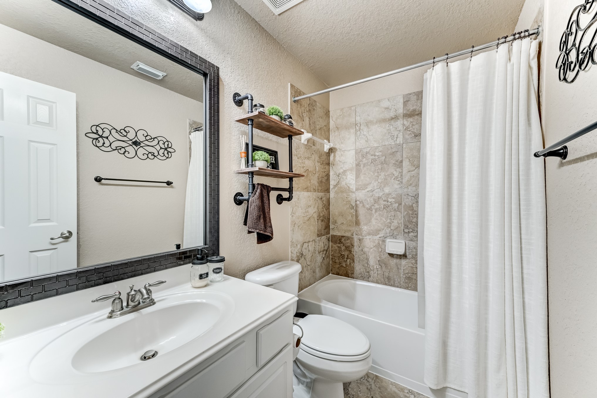 19502 Valkyrie Drive Spring, TX 77379 - Photo 37 of 49 a bathroom with a sink toilet and shower