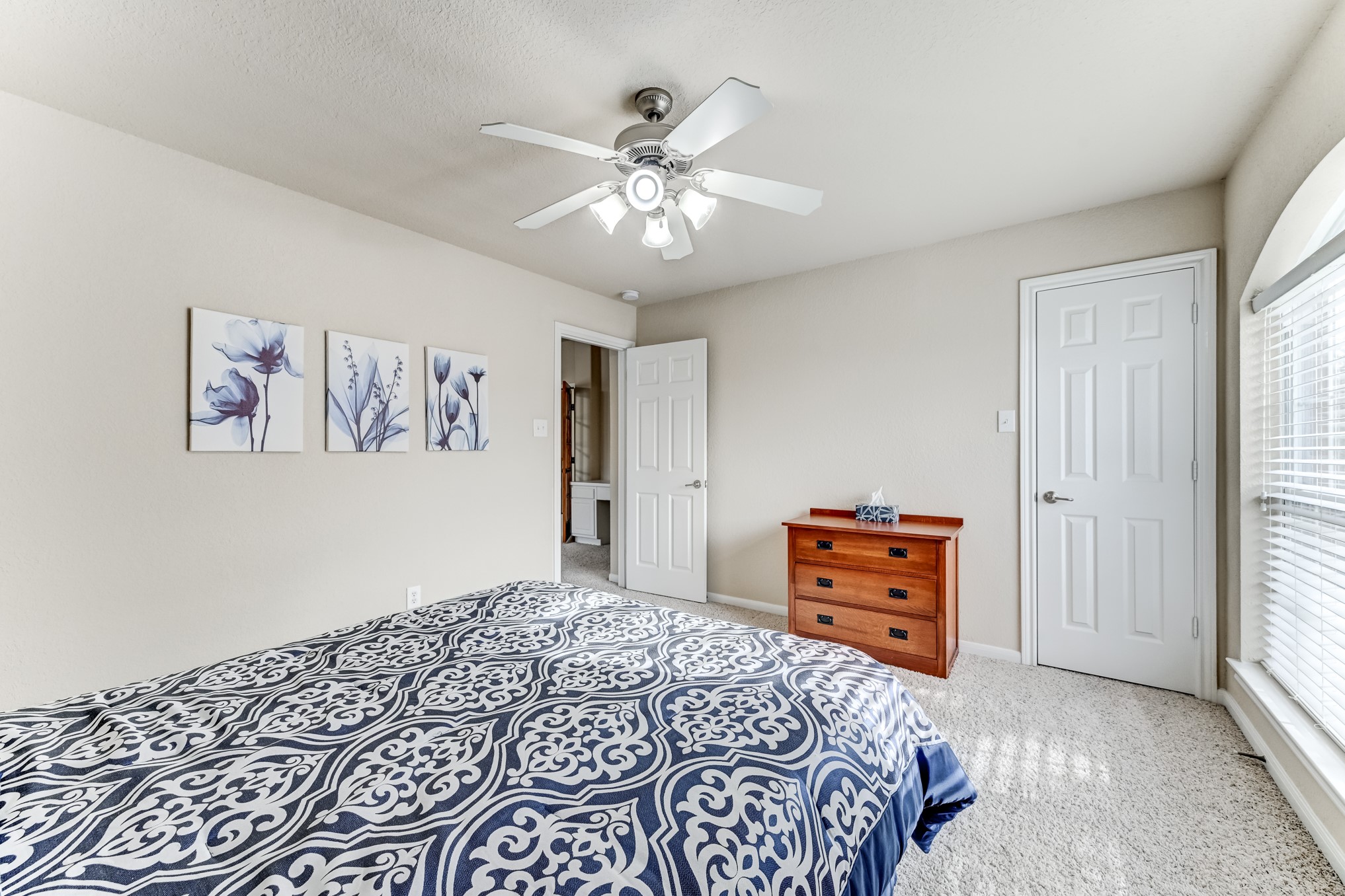 19502 Valkyrie Drive Spring, TX 77379 - Photo 41 of 49 a bedroom with a bed and a chandelier