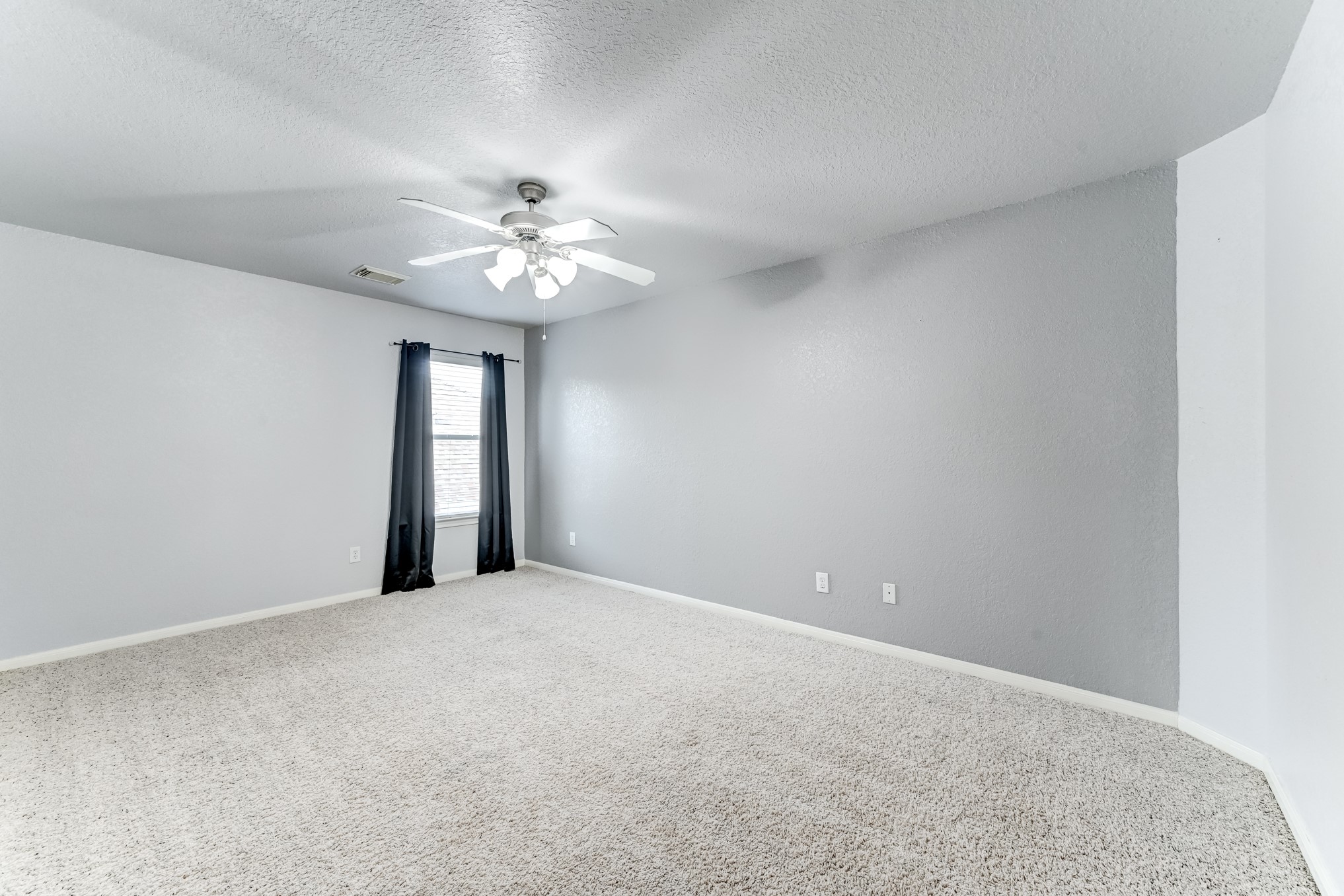 19502 Valkyrie Drive Spring, TX 77379 - Photo 42 of 49 a view of an empty room with a chandelier fan