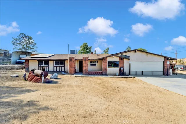 a view of a house with backyard porch and sitting area