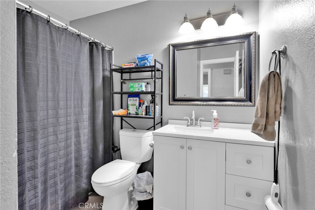 18608 Cocqui Road Apple Valley, CA 92307 - Photo 11 of 30 a bathroom with a toilet sink and mirror