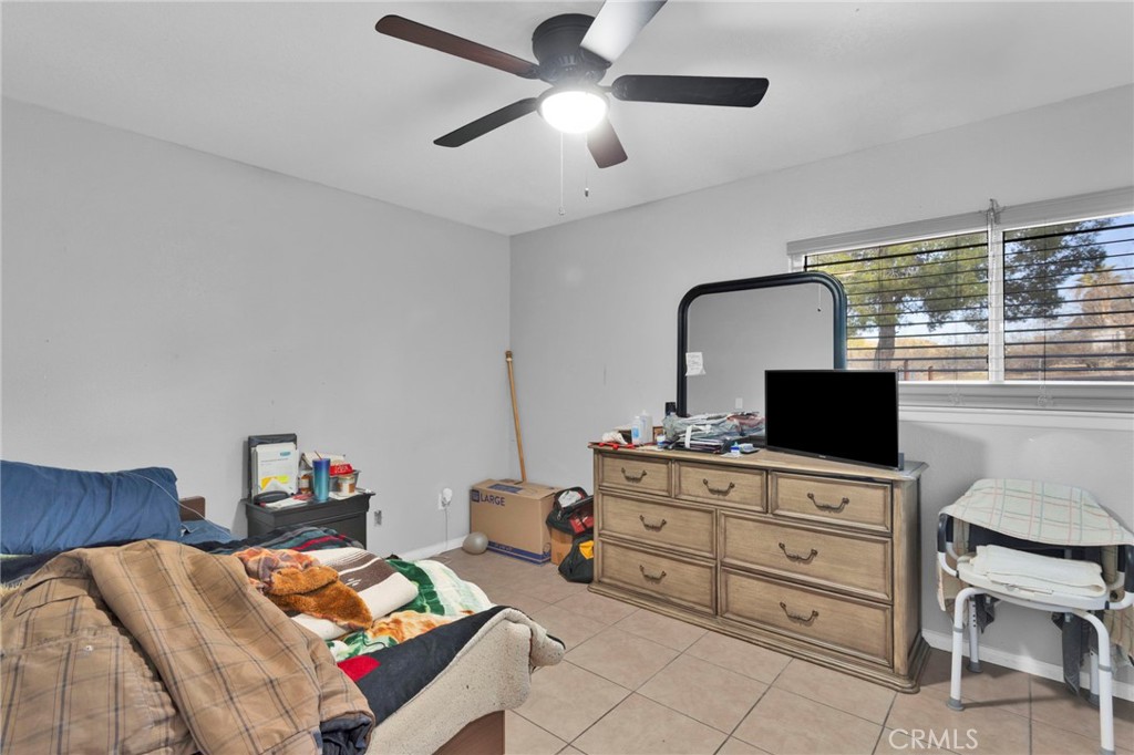 18608 Cocqui Road Apple Valley, CA 92307 - Photo 13 of 30 a bedroom with a bed and furniture