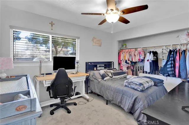a view of a livingroom with workspace and a window