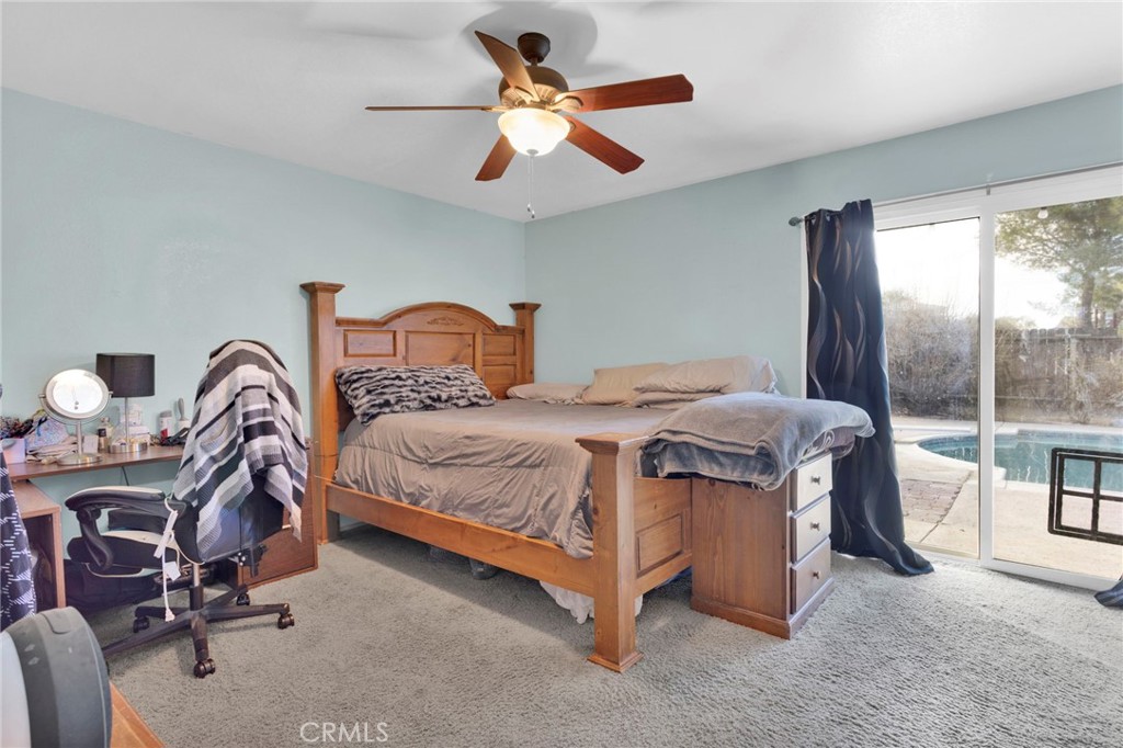 18608 Cocqui Road Apple Valley, CA 92307 - Photo 17 of 30 a bedroom with a bed chair and window