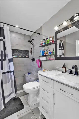 a bathroom with a sink a toilet and a shower