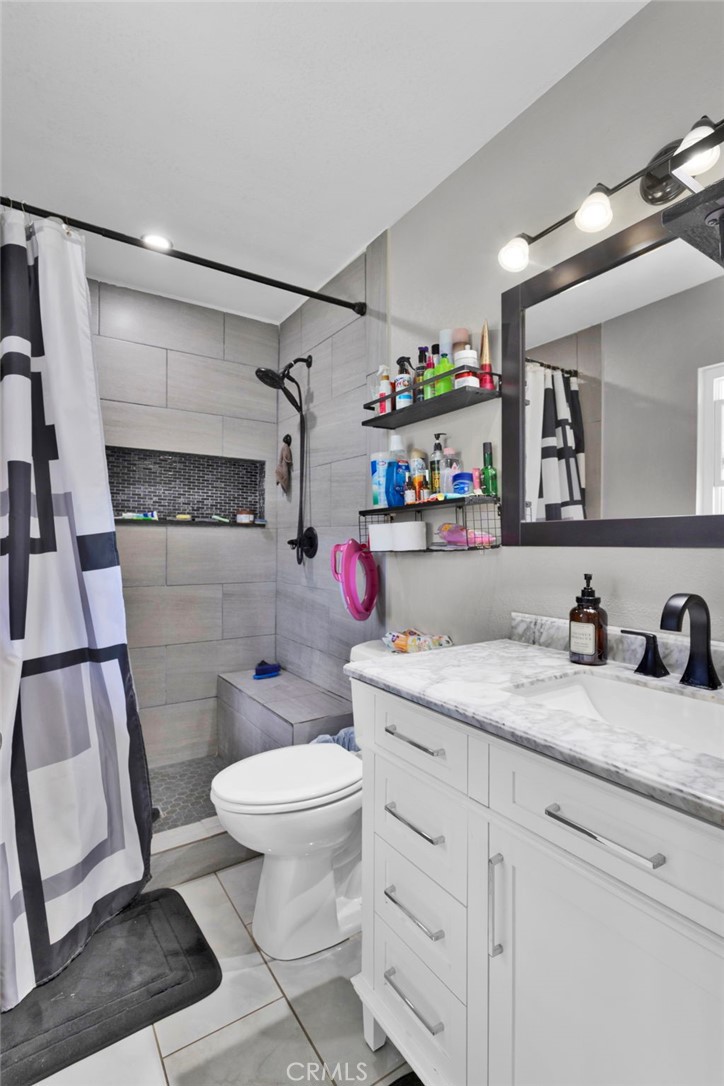 18608 Cocqui Road Apple Valley, CA 92307 - Photo 18 of 30 a bathroom with a sink a toilet and a shower