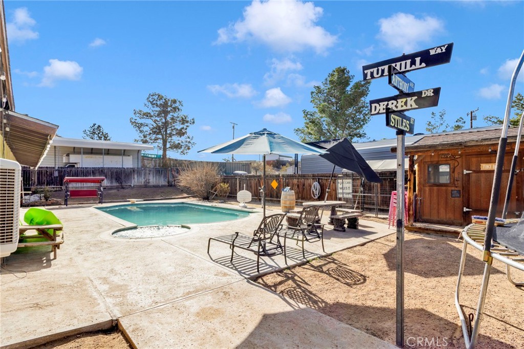 18608 Cocqui Road Apple Valley, CA 92307 - Photo 26 of 30 a patio with glass top table and chairs