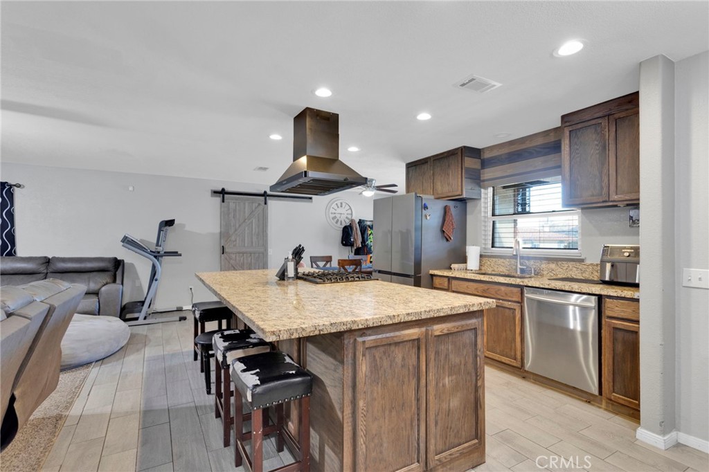 18608 Cocqui Road Apple Valley, CA 92307 - Photo 4 of 30 a kitchen with stainless steel appliances granite countertop a sink a stove and a refrigerator